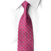 Hot pink rhinestone silk necktie laid flat on white shirt showing full length geometric diamond lattice pattern with silver crystal embellishments and gold tip bar