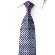 San-Dee RN658 silk tie knotted against a white shirt with navy, silver-gray and plum checkerboard squares and crystal accents.