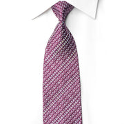 A purple and white patterned necktie knotted on a white collared dress shirt, shown against a plain white background.