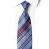 Glacier blue and plum-purple plaid silk necktie knotted against a white shirt, with crystal rhinestone lines and silver sparkles.