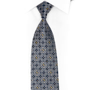 Treliça prateada em gravata de strass azul escuro com brilhos dourados