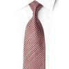 San-Dee dusty-rose and dark-brown checkerboard silk necktie with crystal rhinestones, knotted against a white shirt.