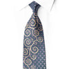 San-Dee navy gold scroll rhinestone silk necktie styled on white dress shirt showing flowing gold spiral motifs over teal-purple geometric diamond ground with crystal rhinestone accents