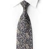 Close-up of San-Dee RN659 tie tip showing gold flowers and leaves on navy silk with curved rows of iridescent crystal rhinestones.