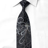 San-Dee black silk rhinestone necktie laid flat on white shirt showing full length with silver sparkle floral motif and crystal rhinestone embellishments